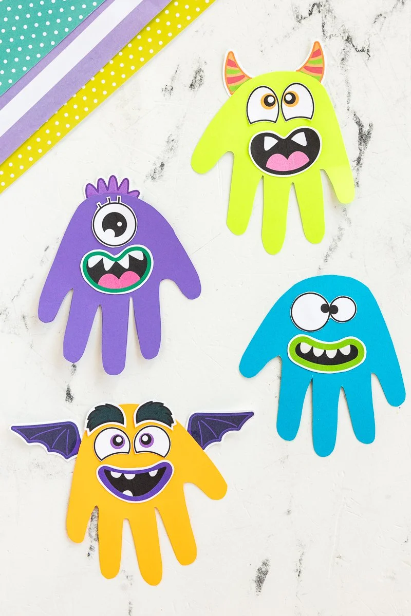 Colorful handprint monsters craft project for kids' art activities.