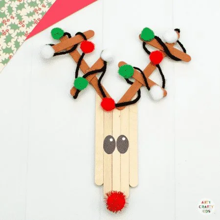 Craft stick reindeer ornament made by Arty Crafty Kids for holiday decoration